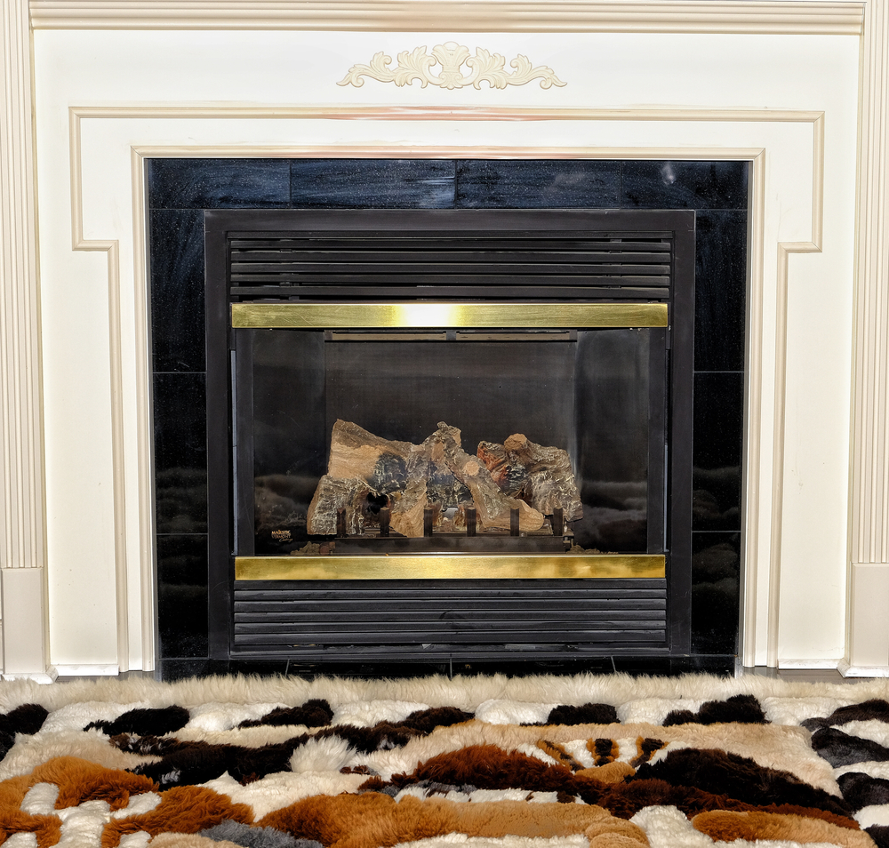 Electric fireplace with cozy designer rug cream colored mantel surrounding