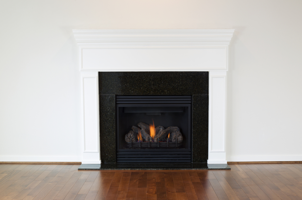 Horizontal photo of A natural gas fireplace with A white